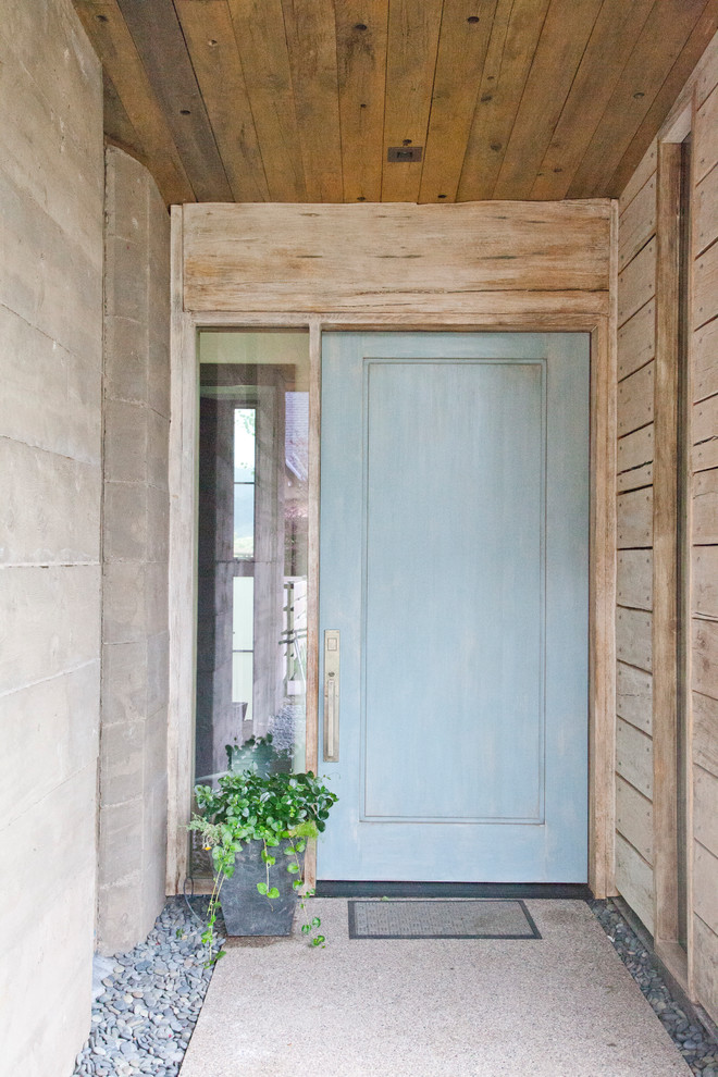 This is an example of a small contemporary front door in Denver with beige walls, a single front door and a blue front door.