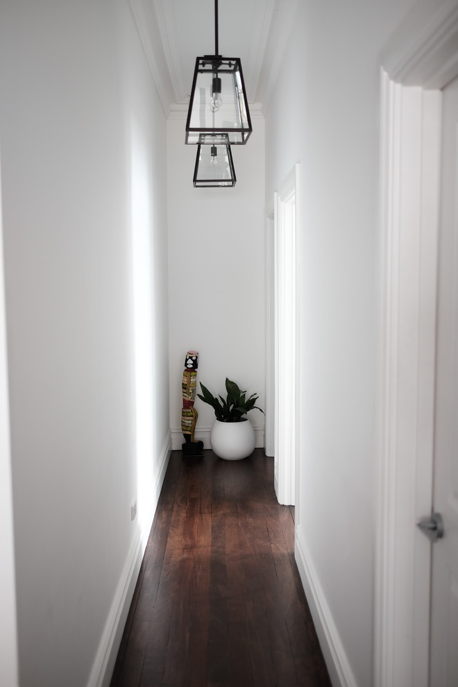 Trendy dark wood floor entryway photo in Perth with white walls