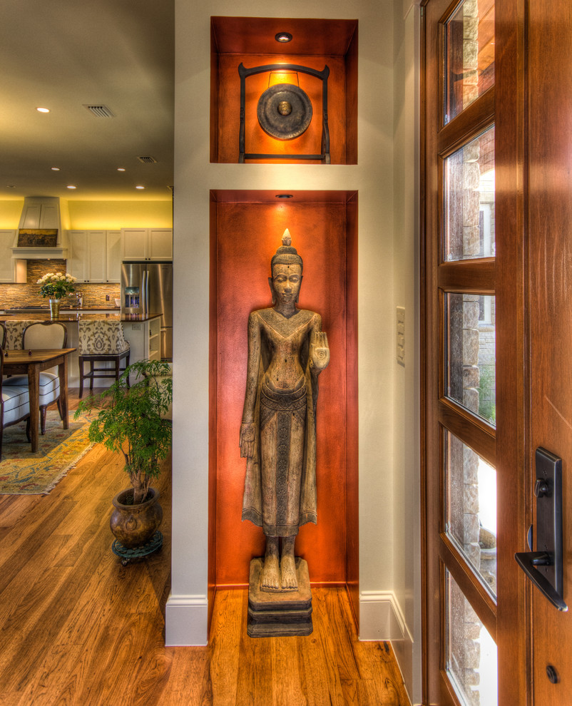 Example of a small eclectic light wood floor and brown floor entryway design in Austin with white walls and a medium wood front door