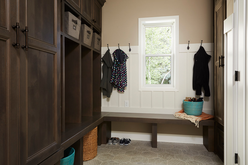 Inspiration for a mid-sized timeless beige floor mudroom remodel in Minneapolis with brown walls