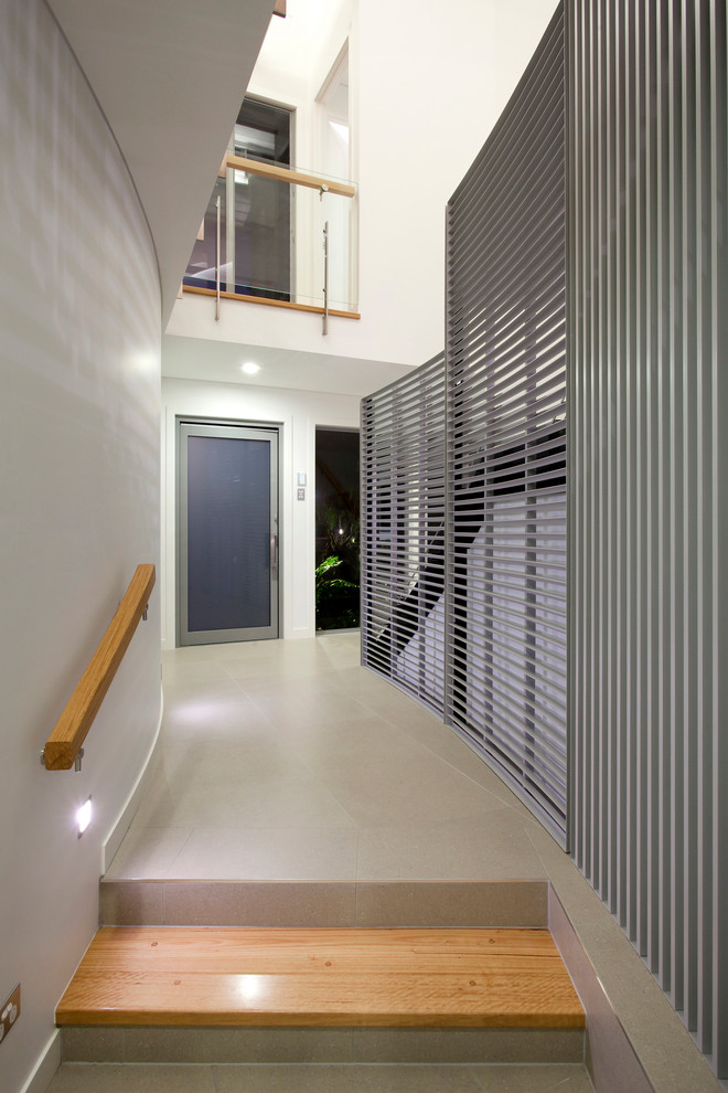 Large contemporary foyer in Brisbane with white walls, ceramic flooring, a pivot front door, a glass front door and grey floors.