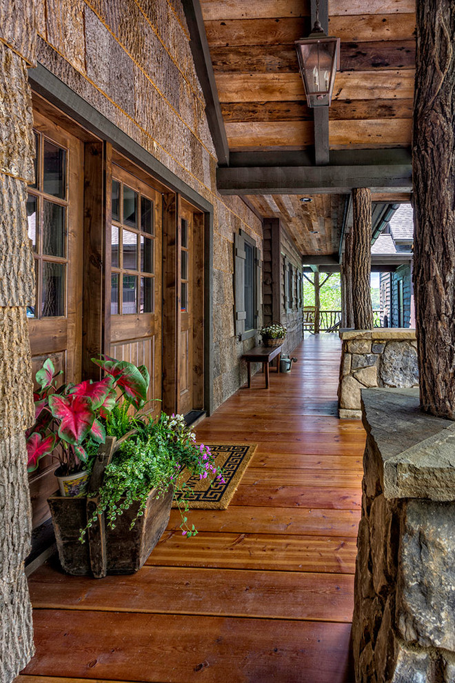 This is an example of a rustic entrance in Other with a dark wood front door, medium hardwood flooring and brown floors.