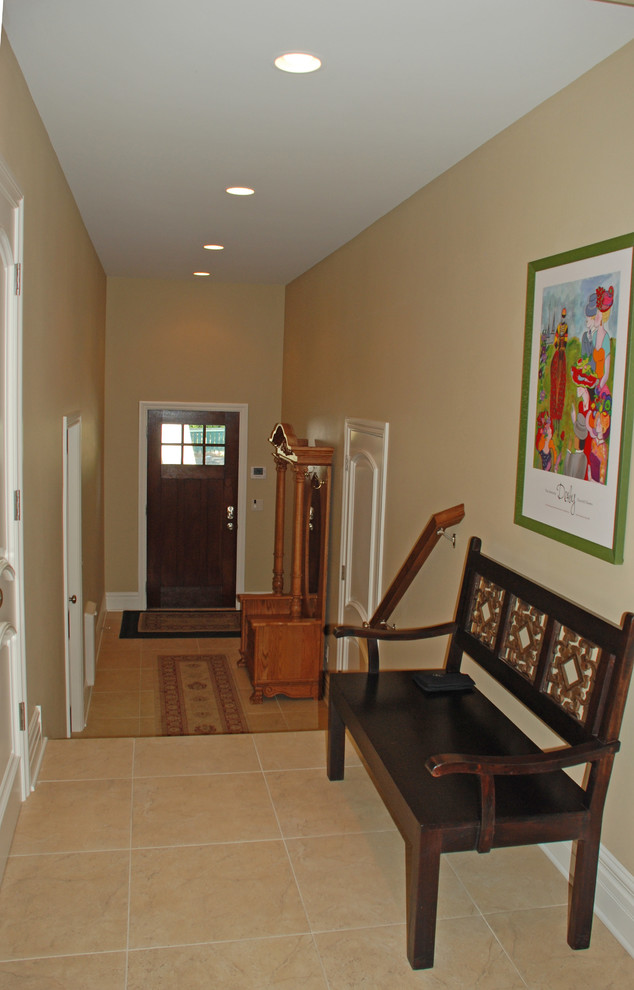 Mid-sized elegant ceramic tile entryway photo in Other with beige walls and a dark wood front door