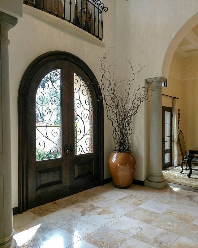 Example of a mid-sized classic marble floor and beige floor entryway design in Orange County with beige walls and a dark wood front door