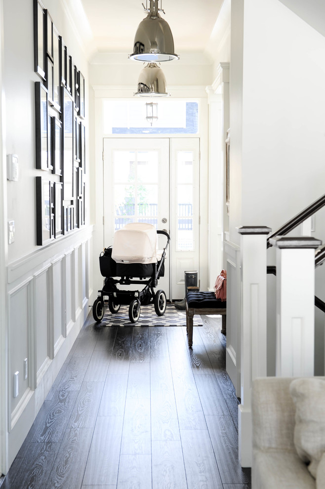 Photo of a classic hallway in Vancouver with white walls, dark hardwood flooring, a double front door and a black front door.