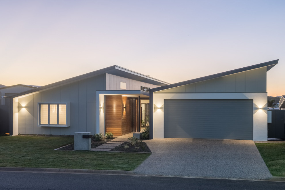 Mid-sized minimalist concrete floor, gray floor and shiplap wall entryway photo in Brisbane with gray walls and a medium wood front door