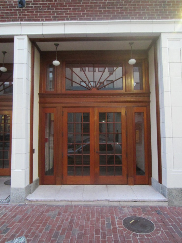 Example of a mid-sized classic marble floor entryway design in Providence with beige walls and a medium wood front door