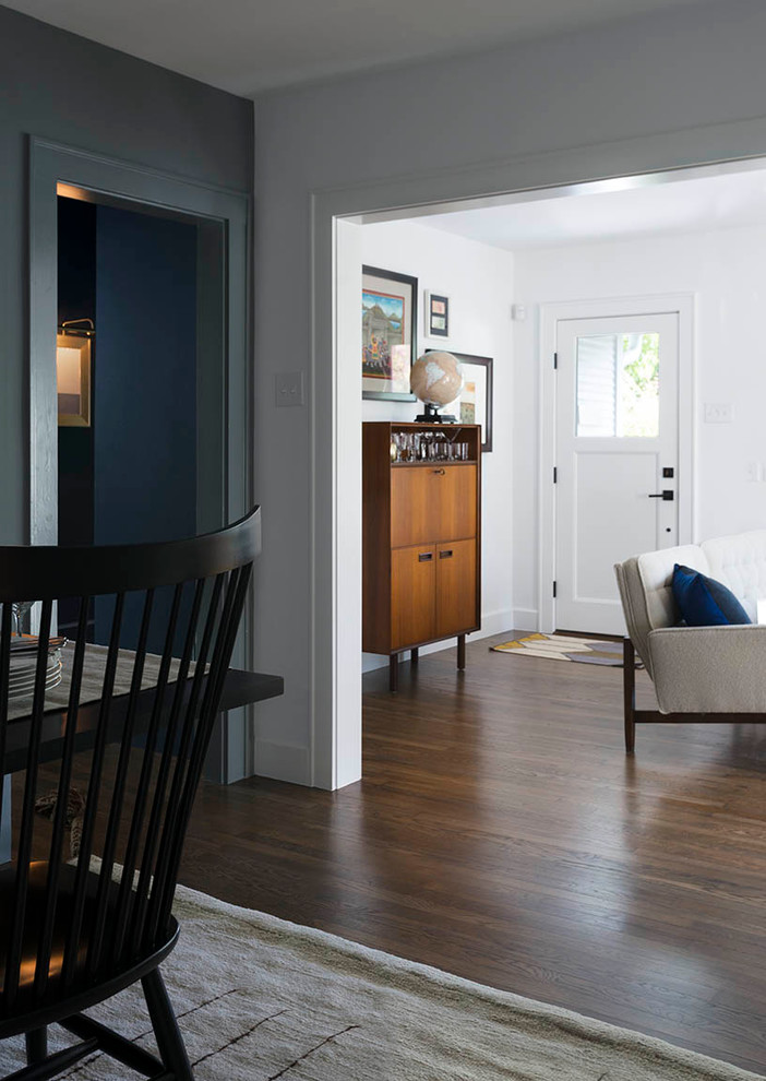This is an example of a small classic entrance in Austin with grey walls and medium hardwood flooring.