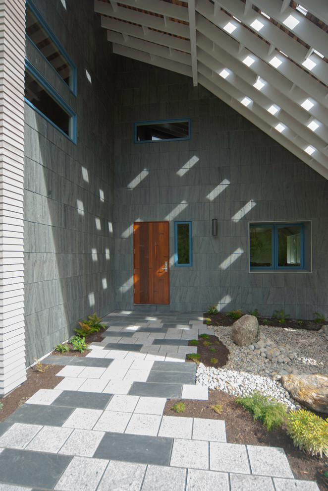 Inspiration for a contemporary entryway remodel in Portland Maine with a medium wood front door