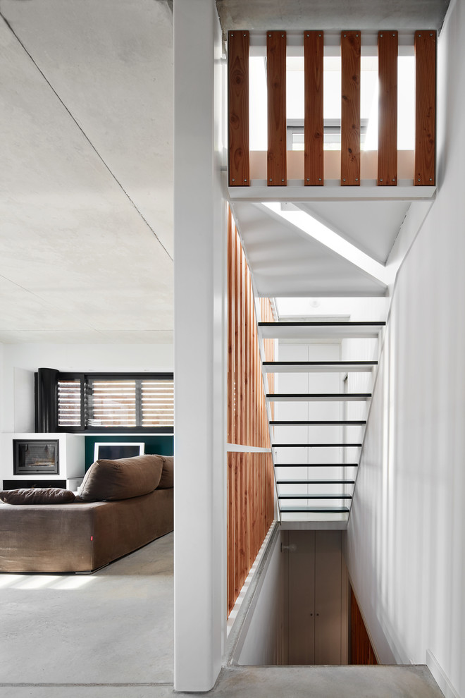 This is an example of a contemporary straight staircase in Other with open risers.