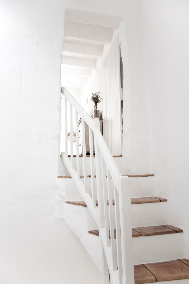 Staircase - mid-sized mediterranean tile u-shaped staircase idea in Barcelona with concrete risers