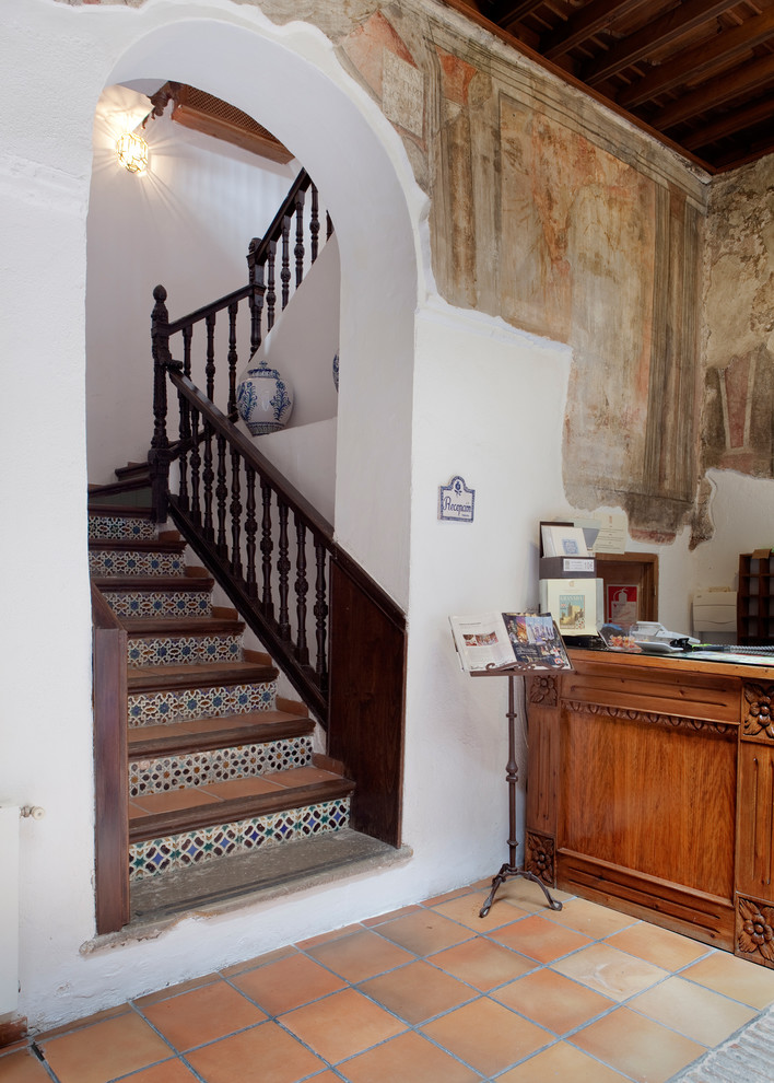 Idée de décoration pour un escalier carrelé chalet en U de taille moyenne avec des contremarches carrelées.