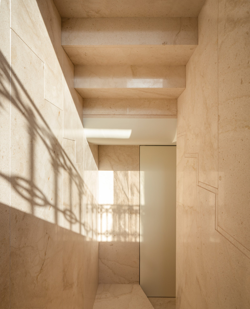 Medium sized contemporary u-shaped staircase in Valencia with limestone treads and limestone risers.