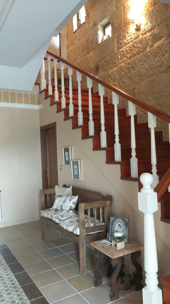 Medium sized farmhouse wood straight staircase in Other with wood risers.