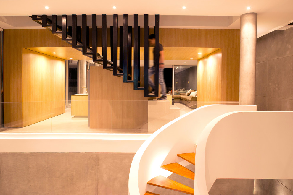 Ejemplo de escalera suspendida contemporánea de tamaño medio con escalones de metal
