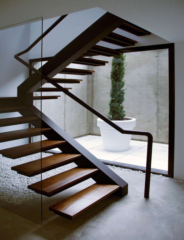 Стильный дизайн: большая п-образная лестница в современном стиле с деревянными ступенями без подступенок - последний тренд