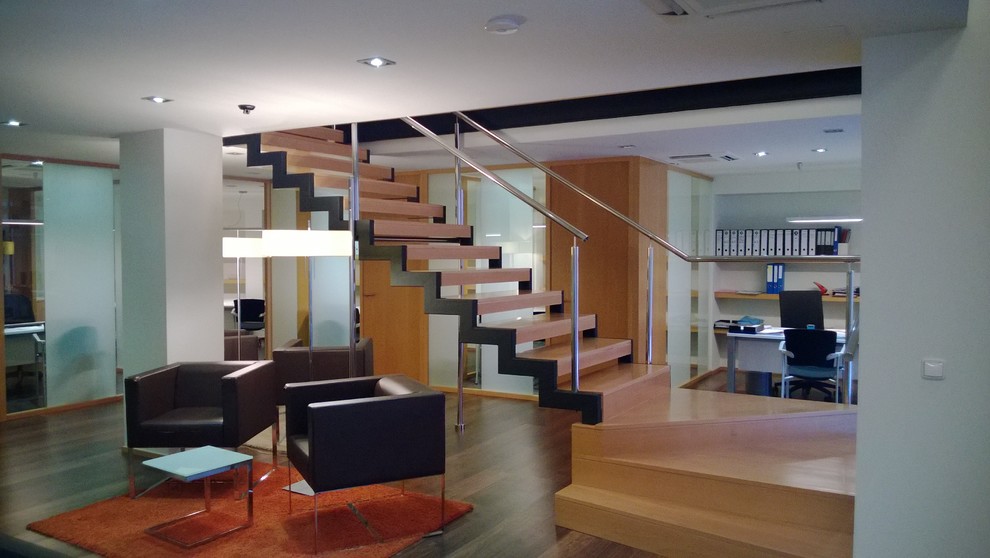 This is an example of a medium sized contemporary wood l-shaped staircase in Malaga with open risers.