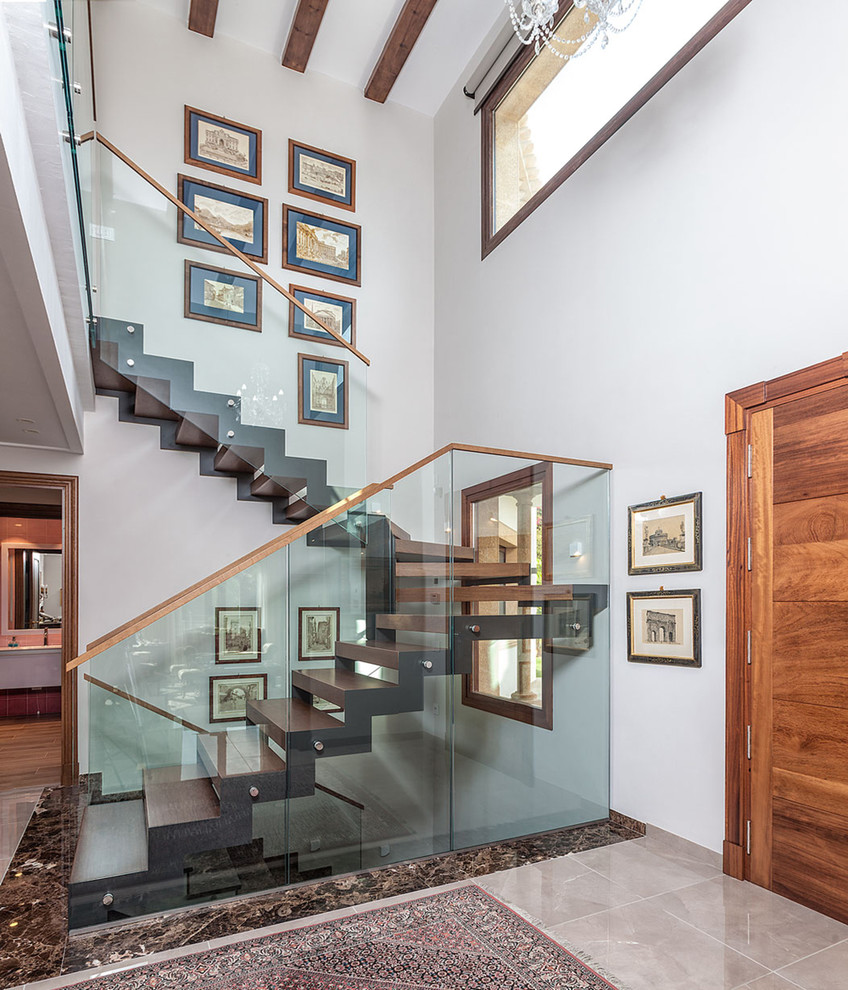 Photo of a contemporary wood glass railing staircase in Alicante-Costa Blanca with open risers.