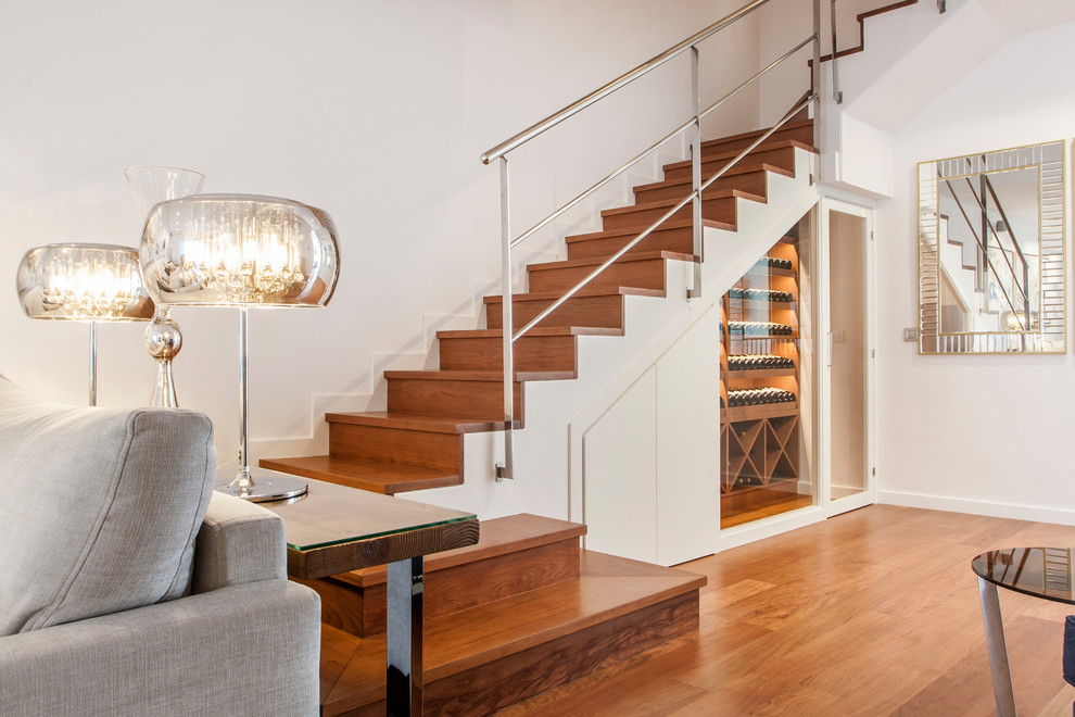 Design ideas for a contemporary wood u-shaped metal railing staircase in Other with wood risers and feature lighting.