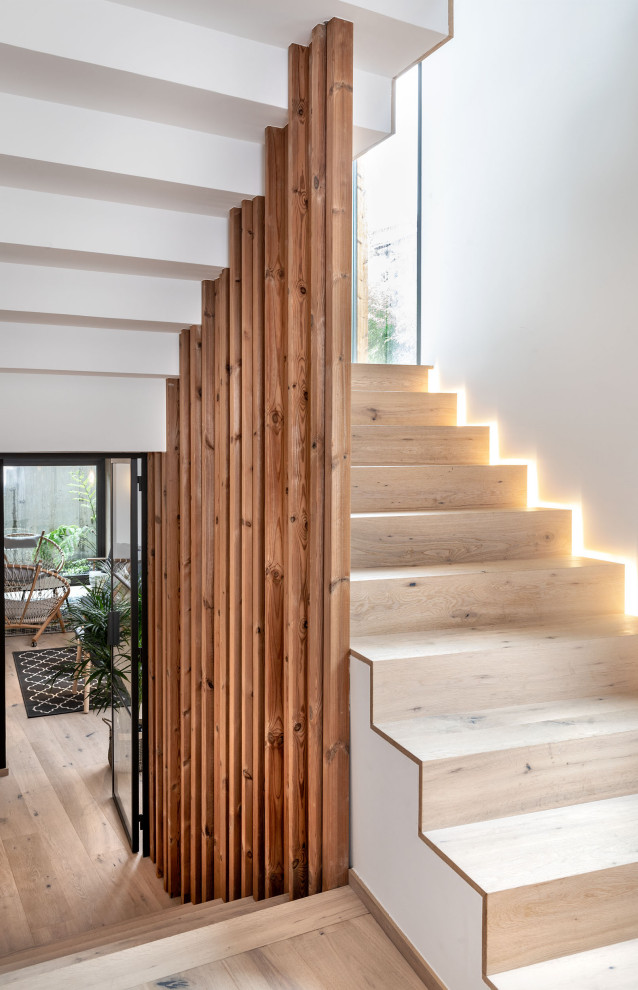 Inspiration for a medium sized world-inspired wood u-shaped wood railing staircase in Other with wood risers.