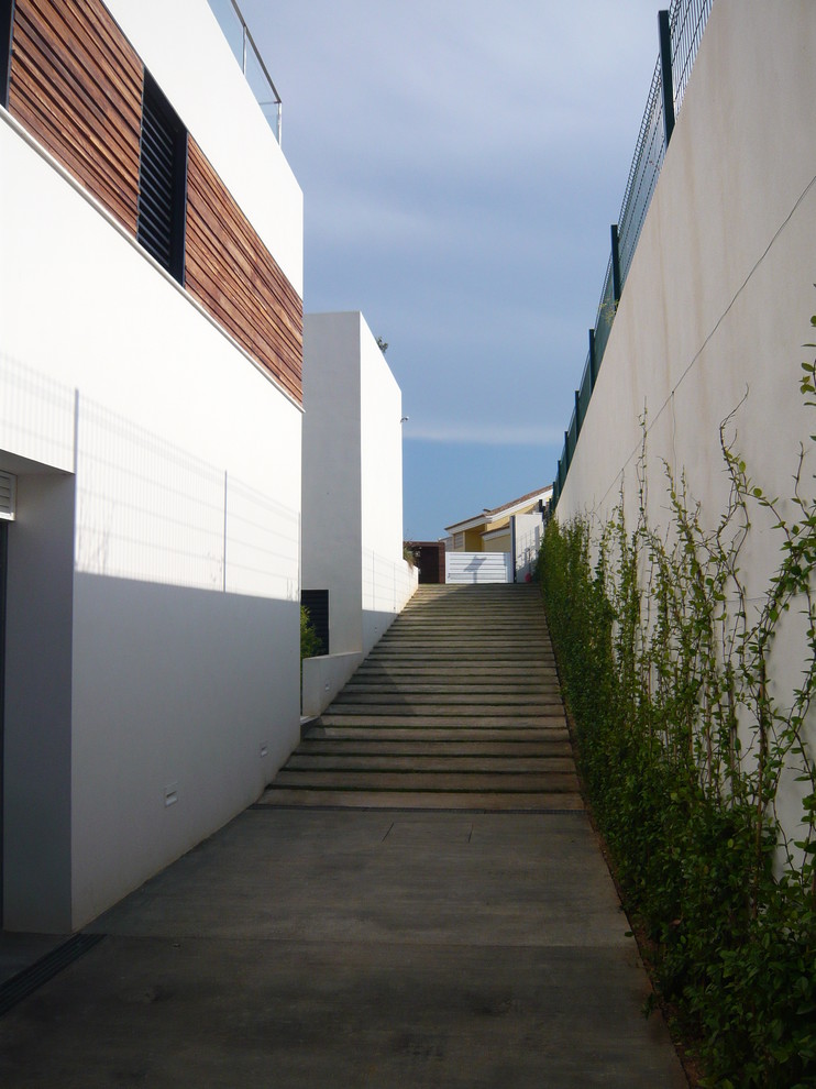 Imagen de escalera recta contemporánea grande con escalones de hormigón