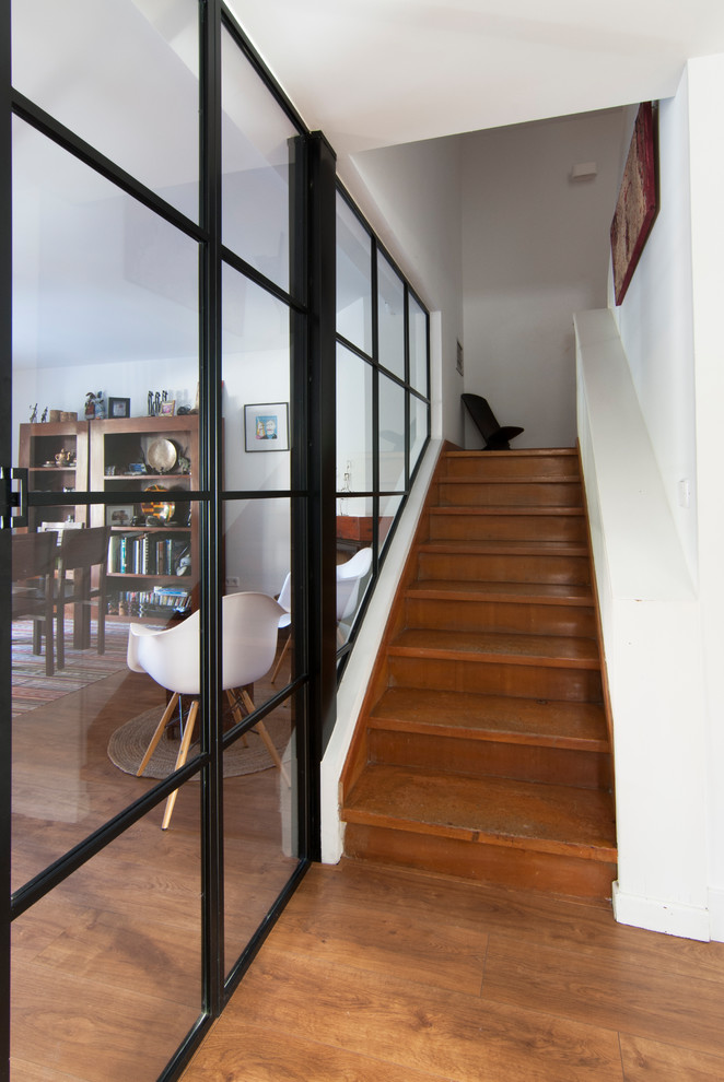 Ejemplo de escalera en U moderna de tamaño medio con escalones de madera, contrahuellas de madera y barandilla de madera