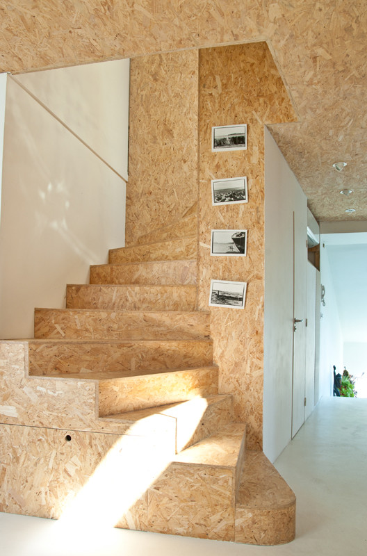 Small trendy wooden curved staircase photo in Montpellier with wooden risers