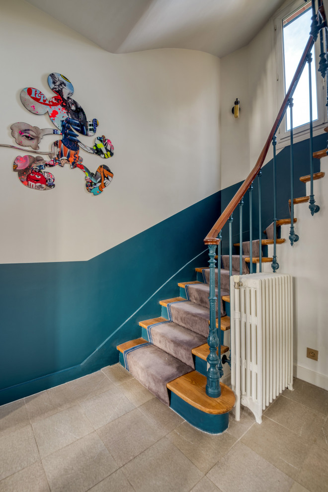 Cette photo montre un escalier peint courbe éclectique avec des marches en bois et un garde-corps en matériaux mixtes.