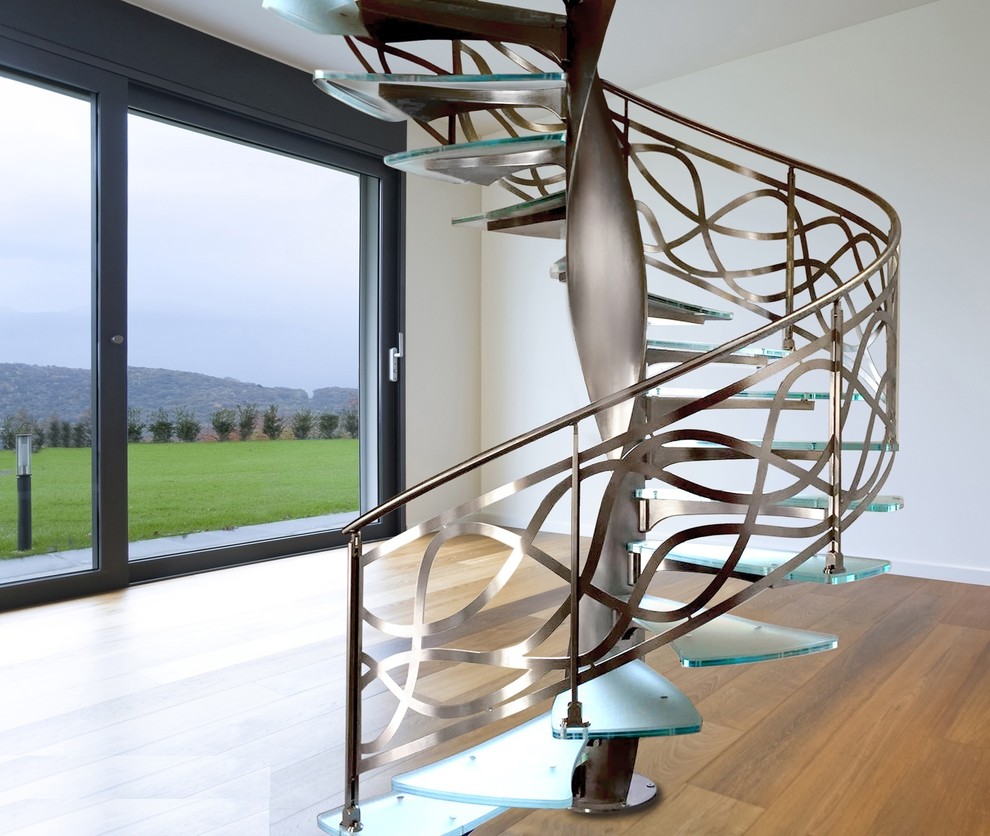 This is an example of a large contemporary metal spiral metal railing staircase in Paris with metal risers.