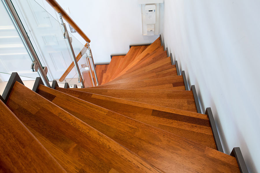 Example of a transitional wooden staircase design in Nice