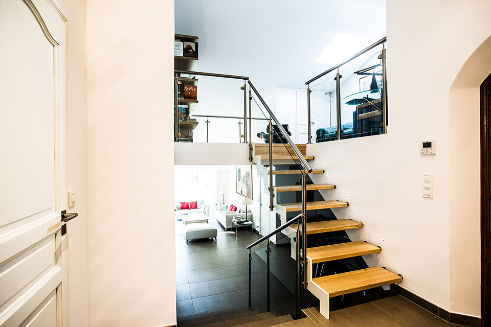 Example of a trendy wooden straight staircase design in Nice