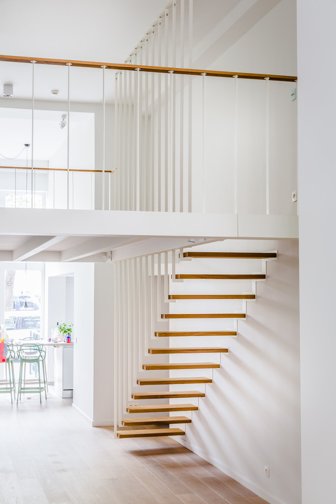Design ideas for a medium sized contemporary wood floating metal railing staircase in Paris.