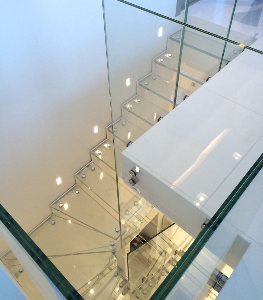 Photo of a contemporary glass u-shaped staircase in Paris with open risers.