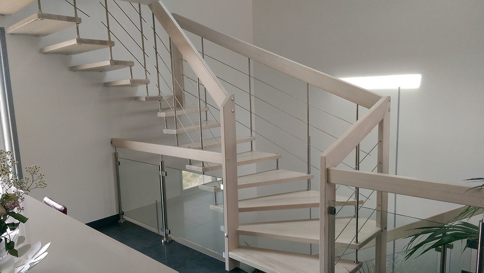 This is an example of a contemporary wood staircase in Nice.