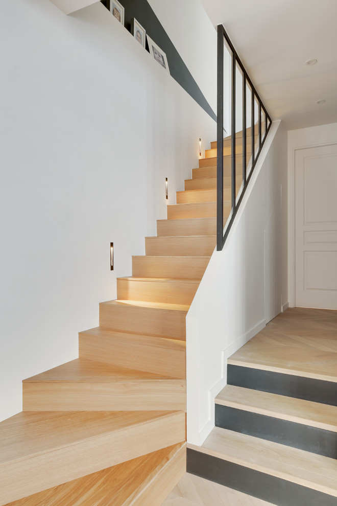 Inspiration for a small contemporary wood l-shaped metal railing staircase in Paris with wood risers.