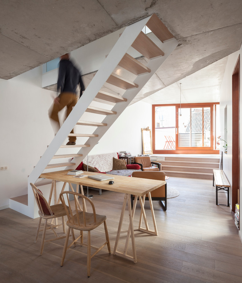 Urban wood straight staircase in Other with open risers.