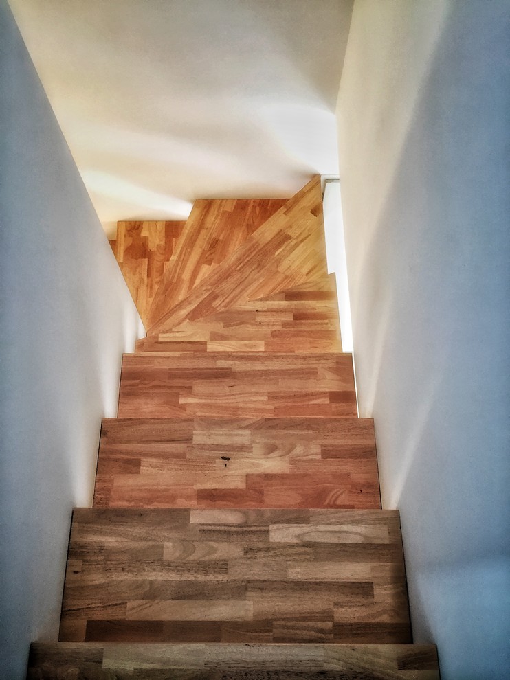 This is an example of a mediterranean wood u-shaped staircase in Montpellier with open risers.