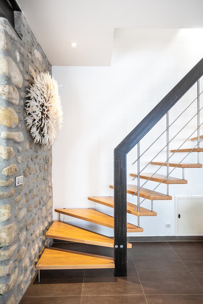 Cette photo montre un escalier sans contremarche tendance en L avec des marches en bois et un garde-corps en métal.