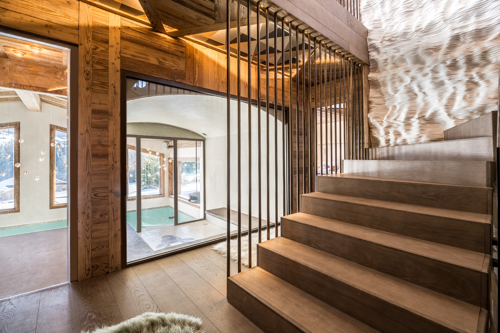 Inspiration for a large rustic wooden curved staircase remodel in Lyon with wooden risers