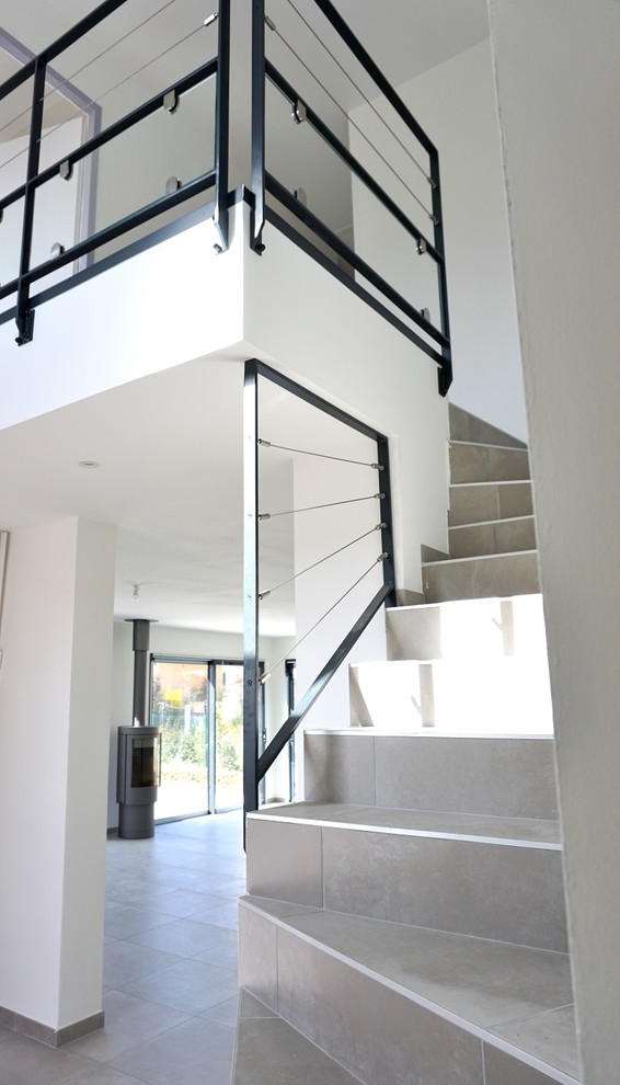 Exemple d'un grand escalier carrelé moderne avec des contremarches carrelées.