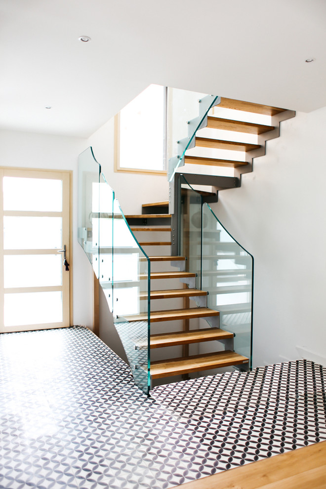 Example of a trendy wooden u-shaped open staircase design in Paris