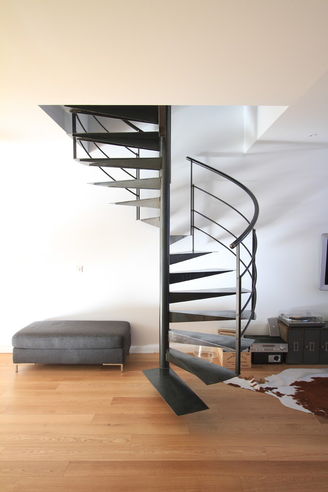 Large contemporary metal spiral staircase in Bordeaux with open risers.