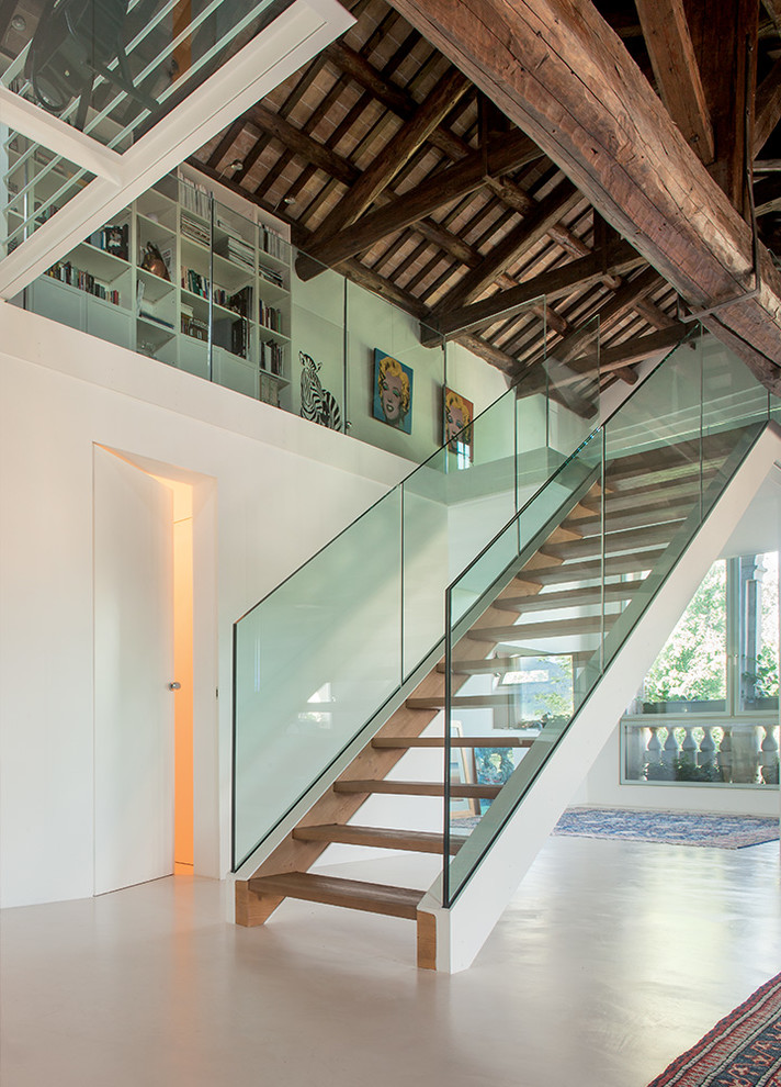 This is an example of a contemporary wood straight staircase in Brest with open risers.