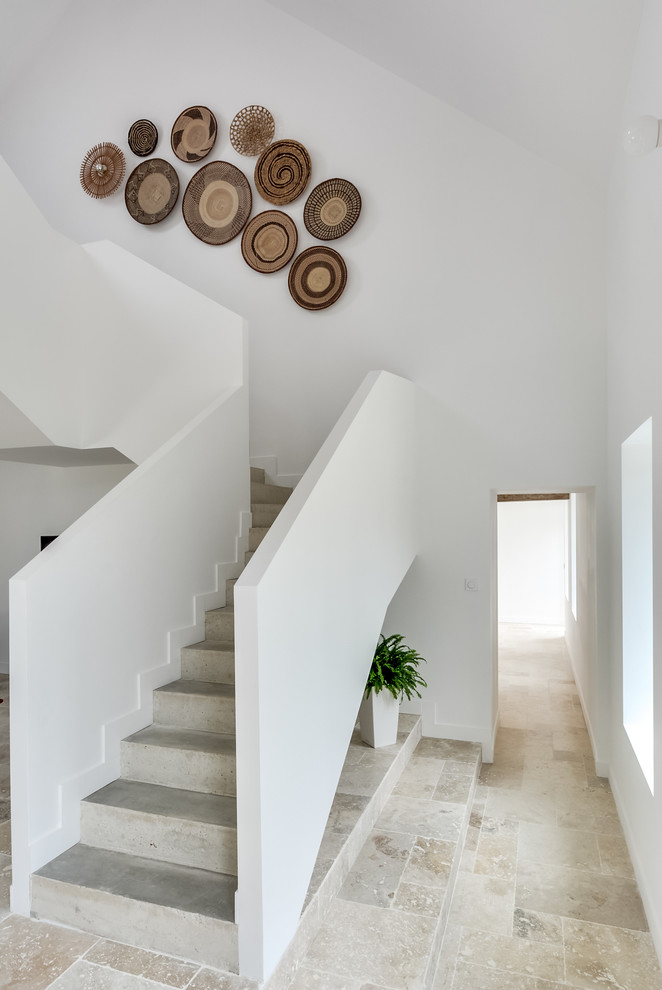 Staircase - mid-sized tropical concrete l-shaped staircase idea in Paris with concrete risers