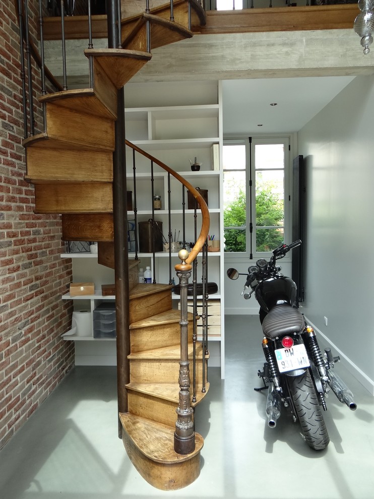 Staircase - industrial wooden spiral mixed material railing staircase idea in Paris with wooden risers
