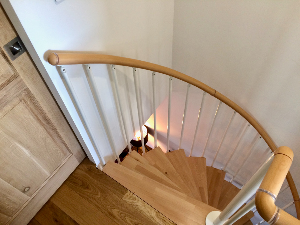 Inspiration for a medium sized contemporary wood spiral metal railing staircase in Montpellier.