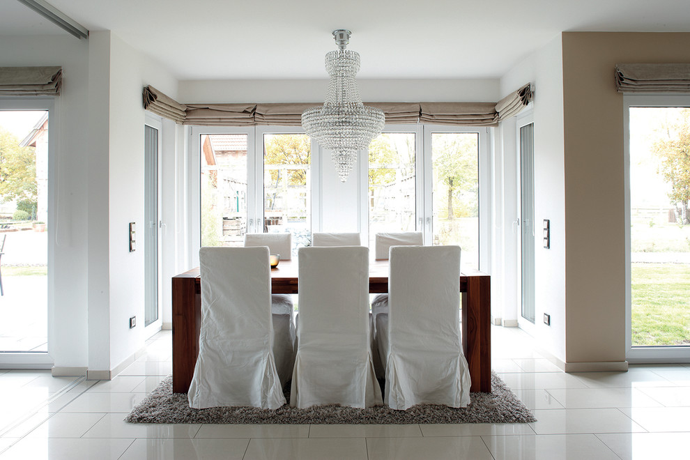 Inspiration for a contemporary open plan dining room in Other with white walls and white floors.