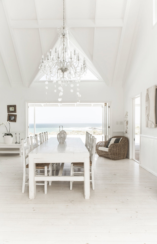 Great room - large coastal light wood floor great room idea in Other with white walls