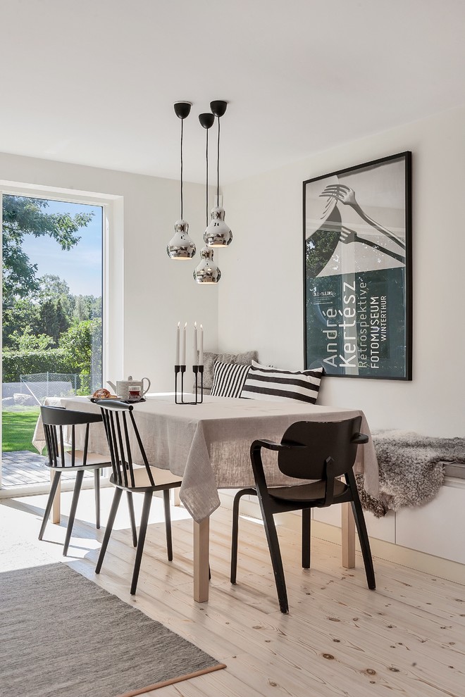 This is an example of a scandi dining room in Other.