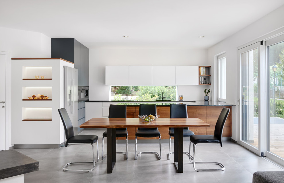 Photo of an expansive contemporary open plan dining room in Other with white walls.
